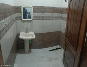 a bathroom with a sink and a mirror at AA Digital Motel in Dargai +2 photos