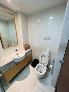 a bathroom with a toilet and a sink and a mirror at Tiger Homestay in Bangkok +32 photos