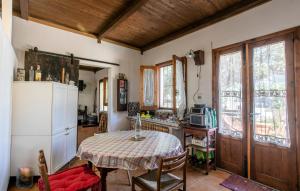 a kitchen with a table and a white refrigerator at Pet Friendly Home In Ragusa With Wifi in Ragusa