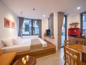 a bedroom with a large bed and a table at DIAMOND Matrix One in Heart of District 1-Luxury Living-Coffee Shop Above in Ho Chi Minh City
