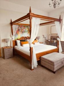 a bedroom with two beds and a canopy bed at Langley House in Langley