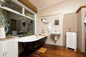 a bathroom with a large tub and a sink at 5-bedroom waterfront home in Endeavour Inlet