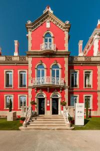 a large red building with a sign in front of it at Meliá São João da Madeira in São João da Madeira