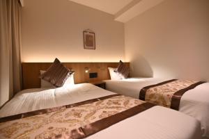 Ένα ή περισσότερα κρεβάτια σε δωμάτιο στο Henn na Hotel Express Osaka Namba Nipponbashi