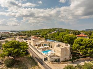an aerial view of a house with a swimming pool at Unique luxury Villa Feriatum Lissa in Ždrelac