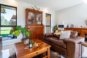 a living room with a couch and a table at 2BR Guest Retreat in Country Home with Shared Hallway in Tarras