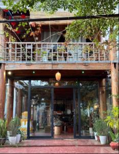 a building with a balcony on top of it at Cô Ba Homestay Măng Đen in Kon Von Kla