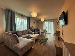 a living room with a couch and a tv at Feels Like Home - free parking and quite area in Timişoara