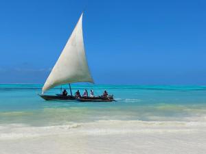 a group of people on a sail boat in the ocean at The Gale House in Umbuji