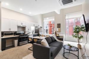 a living room with a couch and a kitchen at Spacious 2BR CozySuites OTR Downtown #12 in Cincinnati +48 photos