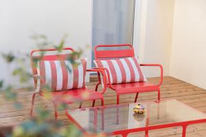 two chairs and a coffee table in a room at Grand Juste in Marseille