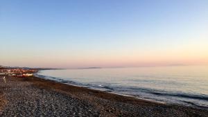 a beach with a boat on the shore at ISA - Felci 19, apartment 6 beds in Marina di Bibbona just 300 mt from the sea in Marina di Bibbona