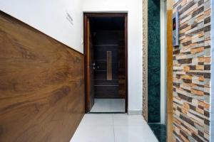 a hallway with a wooden door and a brick wall at Hotel O Grandeur in Méribel Village