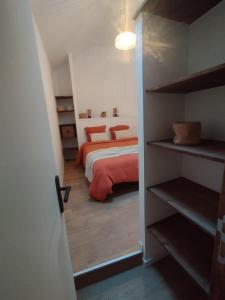 a bedroom with a bed and a book shelf at Duplex centre historique - Château et Loire - tout confort élégant et calme in Saumur