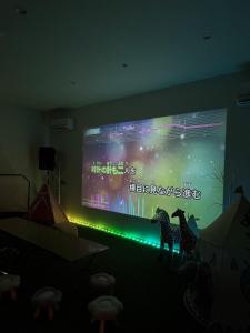 a large screen with a zebra projected on a wall at Ocean House NUI in Katakai