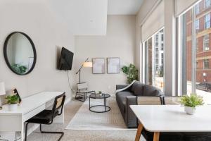 a living room with a couch and a table at Spacious 2BR CozySuites OTR Downtown #10 in Cincinnati