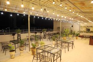 a room with tables and chairs and potted plants at Retro Homestay Hạ Long in Ha Long