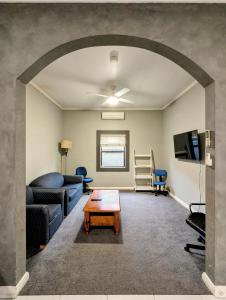 a living room with a couch and a table at Cosy Lodge Mount Gambier close to shopping, eating in Mount Gambier