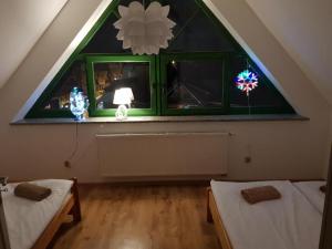 a attic room with two beds and a window at Apartament Pokoje u Jacka Zakopane PKP 700 Centrum 1200 in Zakopane +9 photos