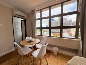 a dining room with a table and chairs and a window at The Keystone Clarke Quay in Singapore