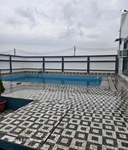 a swimming pool on top of a building with a bridge at Shera farm in Khatauli
