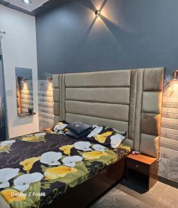 a bedroom with a bed with a large headboard at Shera farm in Khatauli +16 photos