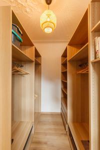 a walk in closet with wooden shelves at Spacious & bright apartment - Top location in Toulon
