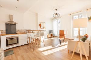 a kitchen and living room with a table and chairs at Spacious & bright apartment - Top location in Toulon