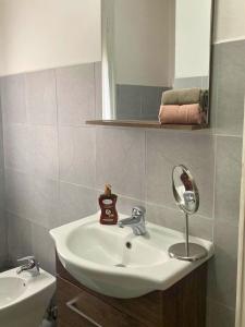 a bathroom with a sink and a mirror at Vista Duomo Ravenna City Center Apartment in Ravenna +28 photos