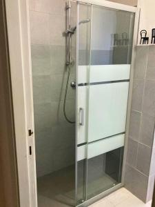 a shower with a glass door in a bathroom at Vista Duomo Ravenna City Center Apartment in Ravenna