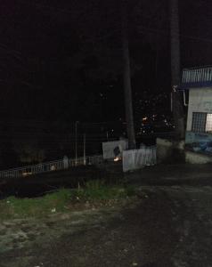 a night time view of a fence and a building at Nabeel Hotel in Dargai