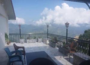 a balcony with a view of the mountains at Nabeel Hotel in Dargai