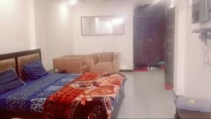 a bedroom with a bed and a living room at Nabeel Hotel in Dargai