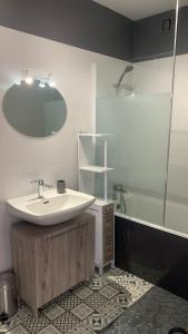 a white bathroom with a sink and a shower at Studio-Soleil Levant 1-Grande plage-Le Barcarès in Le Barcarès