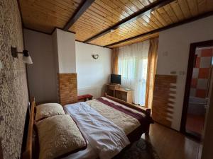 a bedroom with a bed in a room with a window at Pensiunea Namaesti - Inchiriere integrala in Nămăeşti