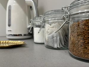 a couple of glass jars filled with nuts on a counter at Coventry Arena Escape in Longford