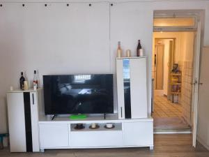 a flat screen tv in a white entertainment center at Cozy room in Passau in Passau