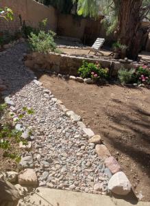 a rock pathway with a bench in a garden at Refugio Caro Cox in Tilcara