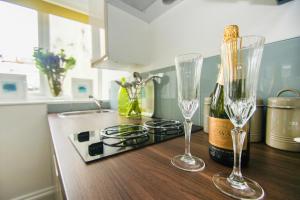 a kitchen with two wine glasses and a bottle of champagne at Between Piers - Central- by Brighton Holiday Lets in Brighton & Hove