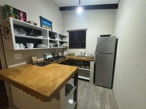 a kitchen with a refrigerator and a table in it at 7 Fonteine Gaste Plaas in Bethlehem