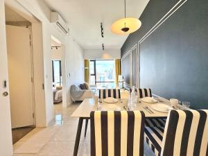 a dining room with a table and some chairs at AXON Residence Kuala Lumpur in Kuala Lumpur
