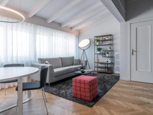 a living room with a couch and a table at Chiaroscuro By Case al Lago in Brescia