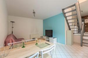a living room with a table and a couch at Le Central in Thonon-les-Bains