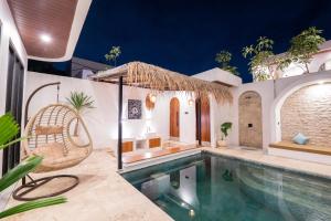 a villa with a swimming pool and a resort at Lavilaya Villa in Kerobokan