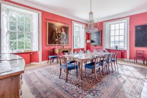 a dining room with red walls and a table and chairs at 5 Bed in Errol oc-t33381 in Errol