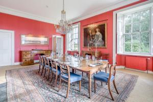 a dining room with red walls and a table and chairs at 5 Bed in Errol oc-t33381 in Errol