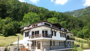 a house with a balcony on a mountain at Къща за гости ДАЯНИЦА in Kopilovtsi