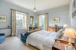 a bedroom with a large bed and two windows at 5 Bed in Errol oc-t33381 in Errol