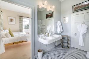 a white bathroom with a sink and a bed at 5 Bed in Errol oc-t33381 in Errol +49 photos