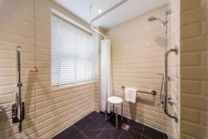 a bathroom with a walk in shower and a sink at The Old Ship Hotel in Brighton & Hove +34 photos